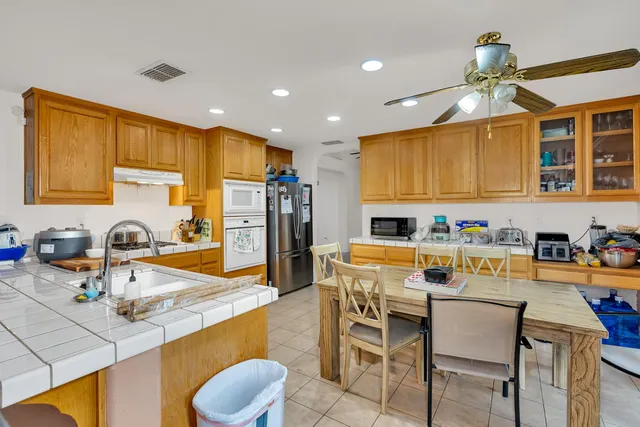 a living room with furniture and a air conditioner vent
