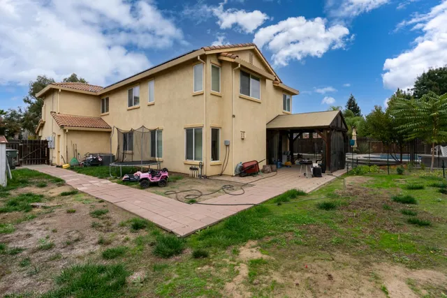 a view of a house with swimming pool and sitting area