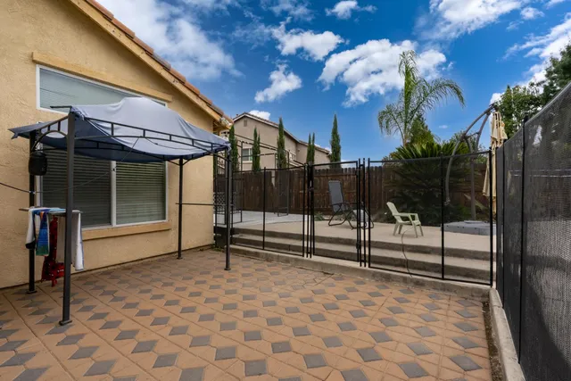 a front view of house with yard outdoor seating and barbeque oven