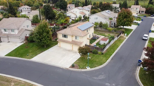 an aerial view of a house with a backyard space