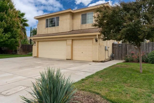 a view of a white house with a large space