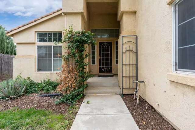 a house with potted plants in front of door