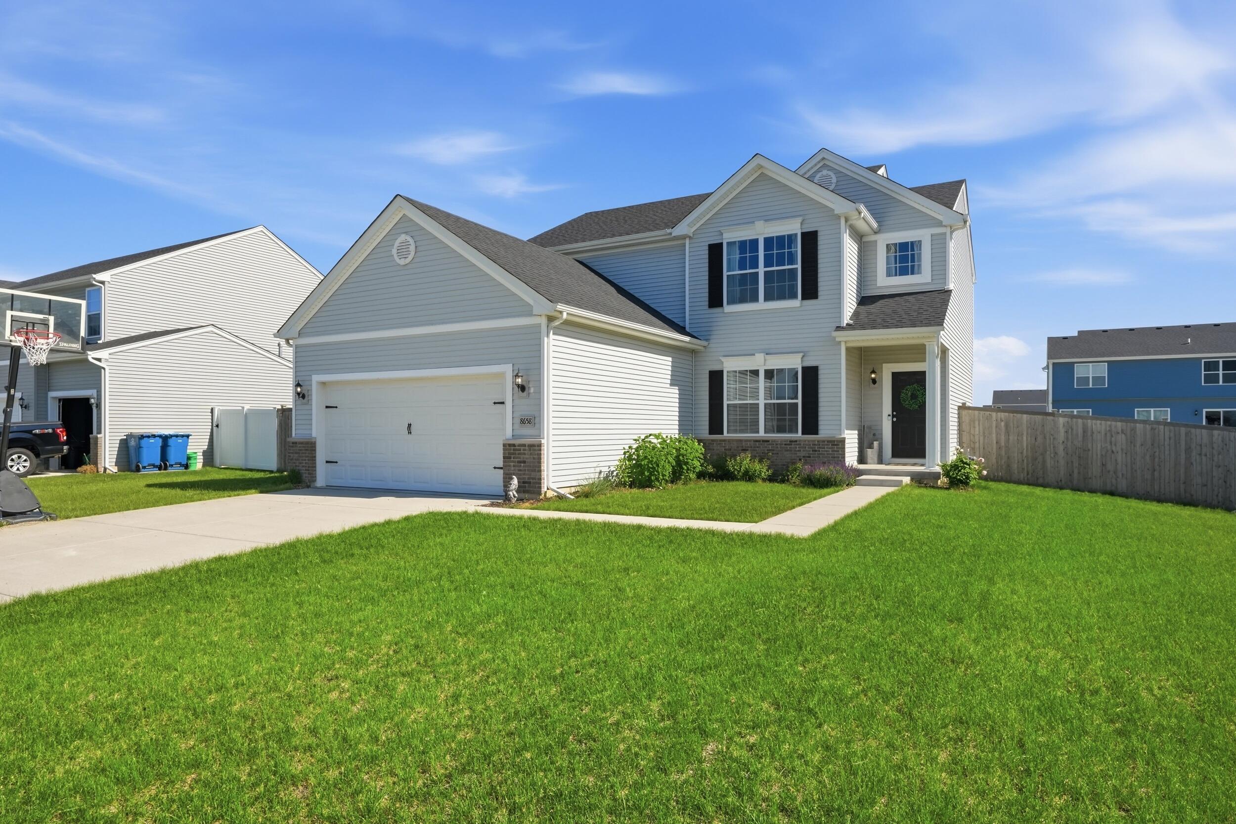 8658 Valley Forge Way Lowell, IN 46356 - Photo 2 of 23 a front view of a house with a yard and garage