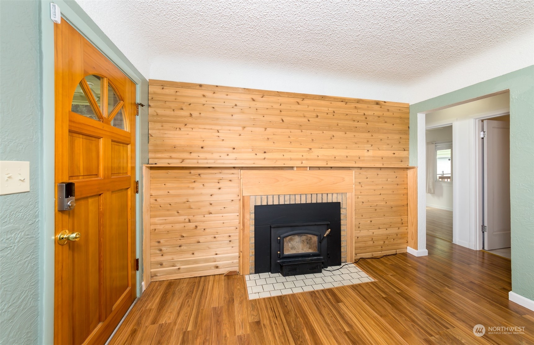 6930 East Cady Road Everett, WA 98203 - Photo 4 of 22 a view of a livingroom with wooden floor and a fireplace