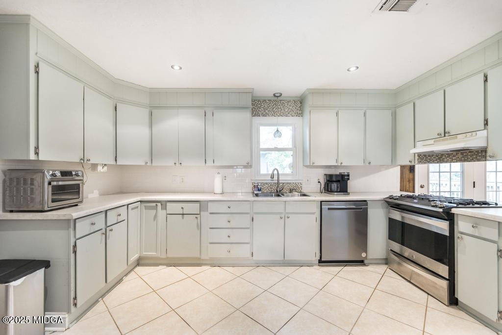 4112 West Hickory Court Macon, GA 31210 - Photo 3 of 12 a kitchen with white cabinets stainless steel appliances and a sink