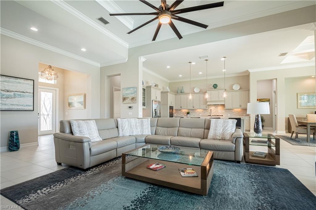 6262 Lightbourn Way Naples, FL 34113 - Photo 13 of 49 a living room with furniture and a large window