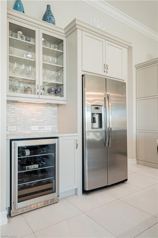 6262 Lightbourn Way Naples, FL 34113 - Photo 18 of 49 a kitchen with granite countertop a refrigerator and a stove