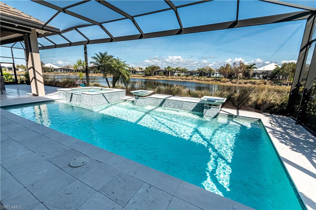 6262 Lightbourn Way Naples, FL 34113 - Photo 2 of 49 a view of a swimming pool with a patio
