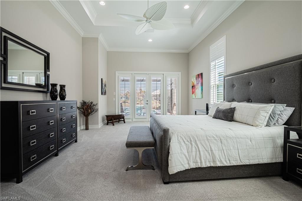 6262 Lightbourn Way Naples, FL 34113 - Photo 22 of 49 a bedroom with a bed a couch and dresser