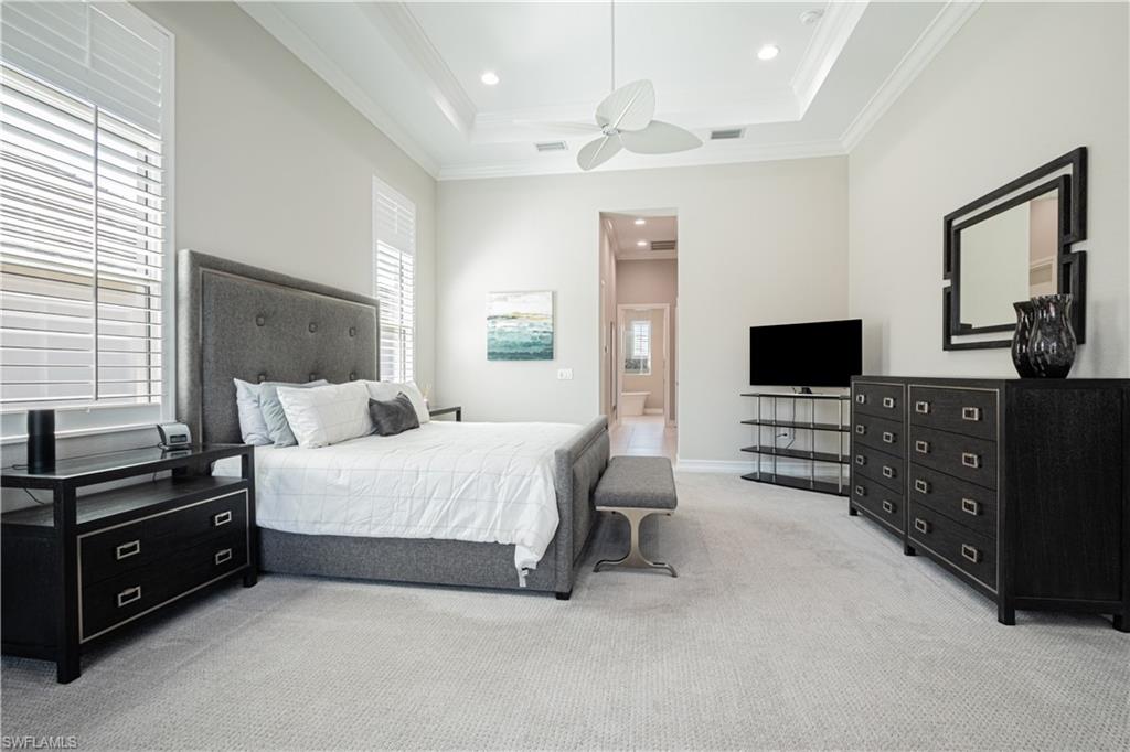 6262 Lightbourn Way Naples, FL 34113 - Photo 23 of 49 a spacious bedroom with a bed and furniture