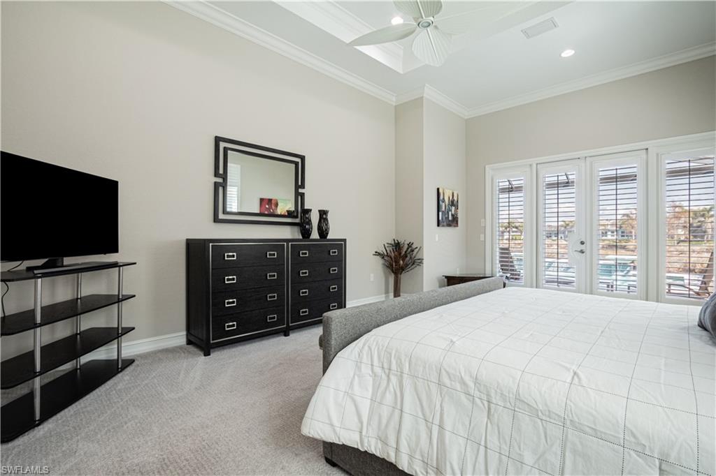 6262 Lightbourn Way Naples, FL 34113 - Photo 24 of 49 a bedroom with a bed and a flat screen tv