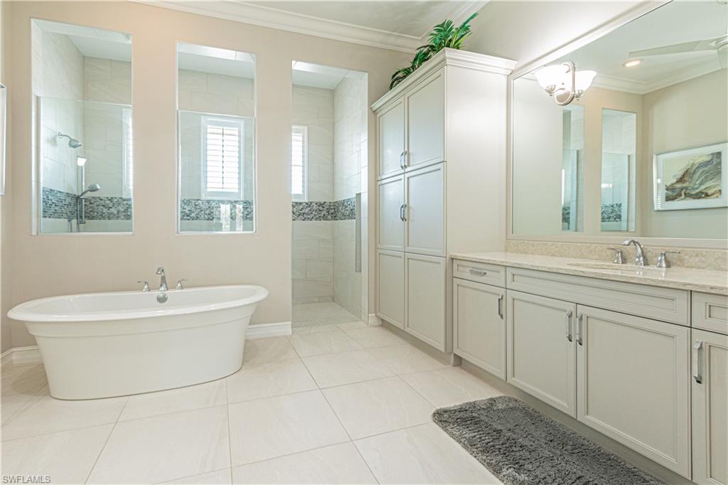 6262 Lightbourn Way Naples, FL 34113 - Photo 25 of 49 a bathroom with a double vanity sink mirror and bathtub