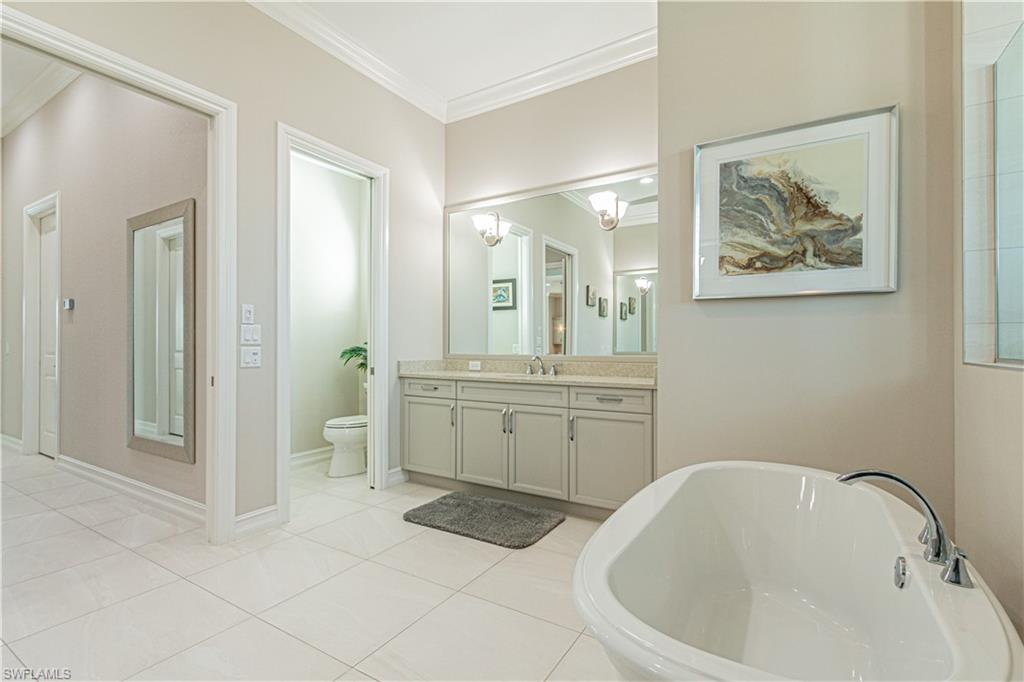 6262 Lightbourn Way Naples, FL 34113 - Photo 27 of 49 a bathroom with a bathtub sink and mirror