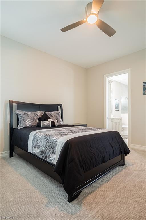 6262 Lightbourn Way Naples, FL 34113 - Photo 29 of 49 a bedroom with a bed lamp and a ceiling fan
