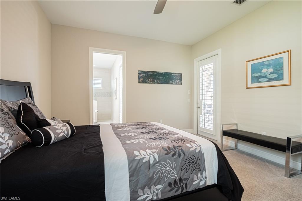 6262 Lightbourn Way Naples, FL 34113 - Photo 30 of 49 a bedroom with a bed and wooden floor