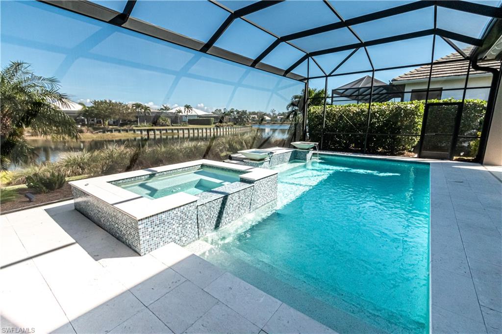 6262 Lightbourn Way Naples, FL 34113 - Photo 3 of 49 a view of a swimming pool with a patio