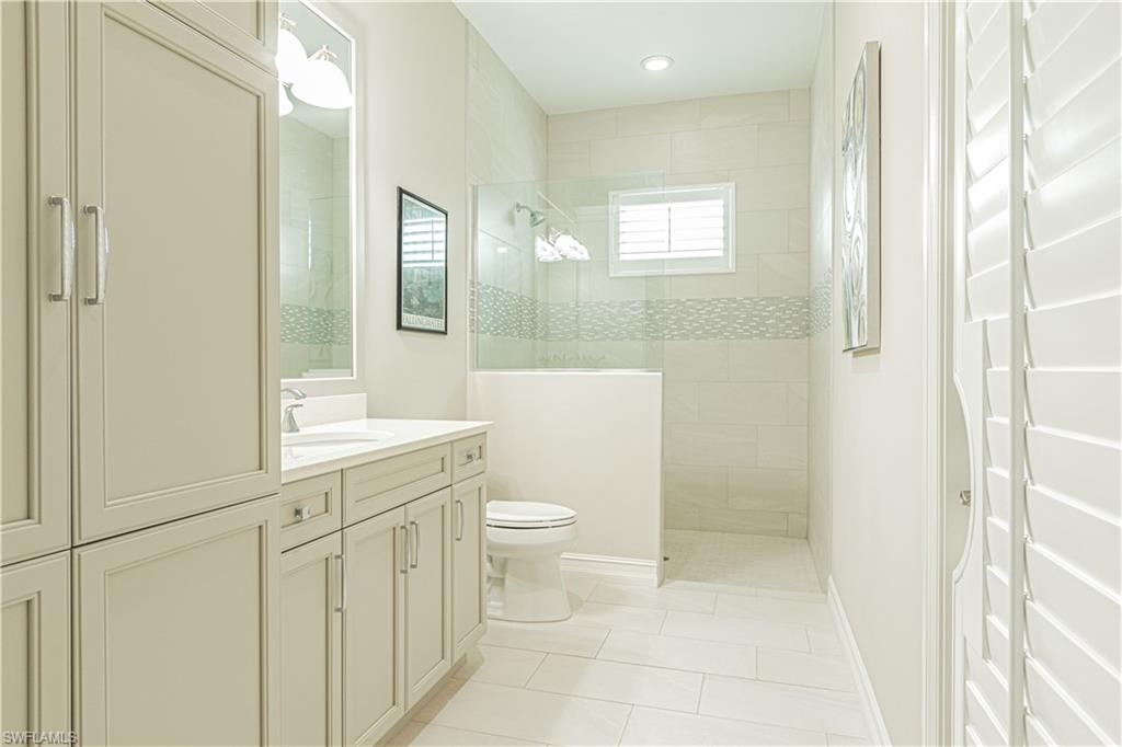 6262 Lightbourn Way Naples, FL 34113 - Photo 31 of 49 a bathroom with a sink a toilet a mirror and shower
