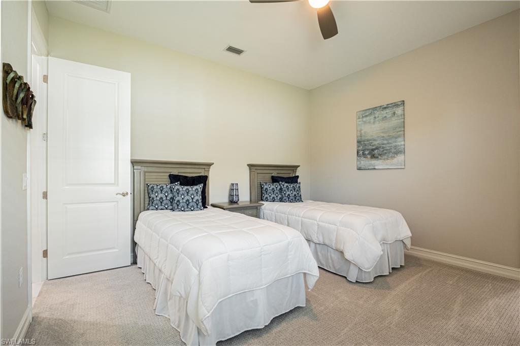 6262 Lightbourn Way Naples, FL 34113 - Photo 32 of 49 a bedroom with two beds and painted walls