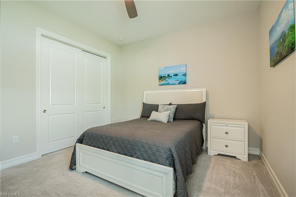 6262 Lightbourn Way Naples, FL 34113 - Photo 35 of 49 a bedroom with a bed and a window