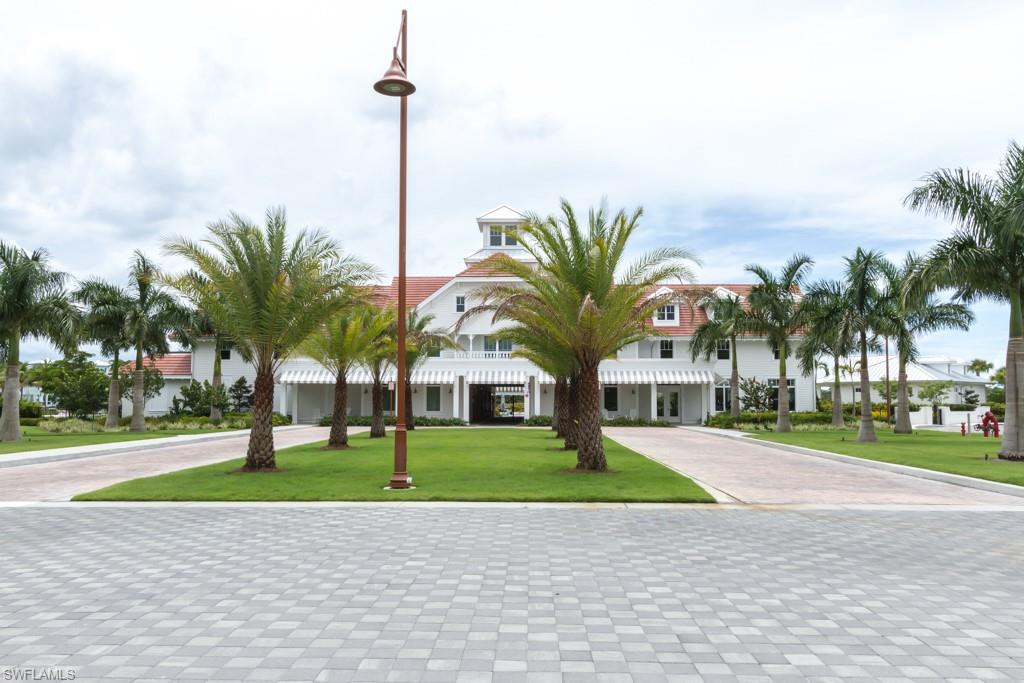6262 Lightbourn Way Naples, FL 34113 - Photo 42 of 49 a building with palm trees in front of it