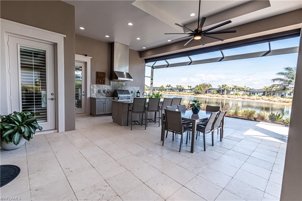 6262 Lightbourn Way Naples, FL 34113 - Photo 5 of 49 a dining room with furniture and a floor to ceiling window