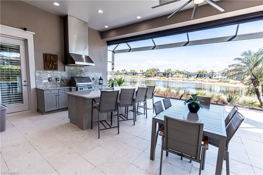 6262 Lightbourn Way Naples, FL 34113 - Photo 6 of 49 a dining room with stainless steel appliances granite countertop a stove top oven dining table chairs and view kitchen