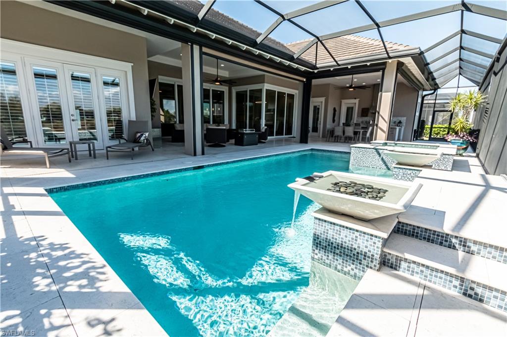 6262 Lightbourn Way Naples, FL 34113 - Photo 8 of 49 a view of a swimming pool with a patio