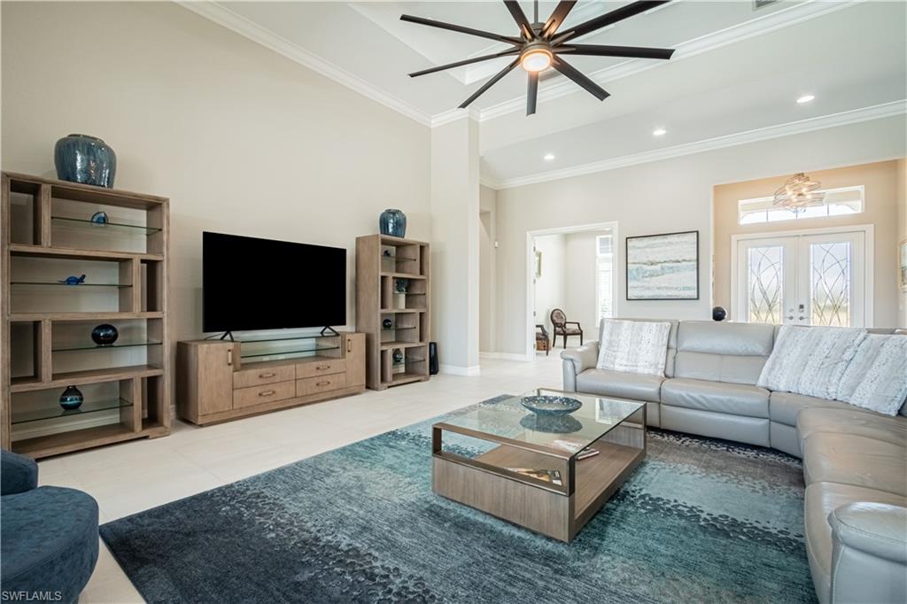 6262 Lightbourn Way Naples, FL 34113 - Photo 10 of 49 a living room with furniture and a flat screen tv