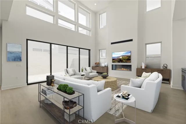 a living room with fireplace furniture and a large window