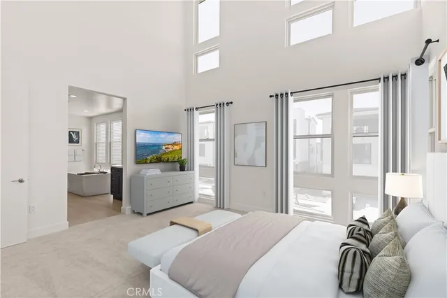 a bedroom with furniture and a large window