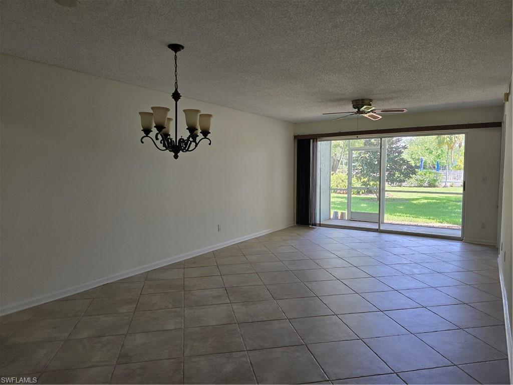 5737 Whitaker Road, Unit C104 Naples, FL 34112 - Photo 16 of 35 Living area with chandelier and ceiling fan