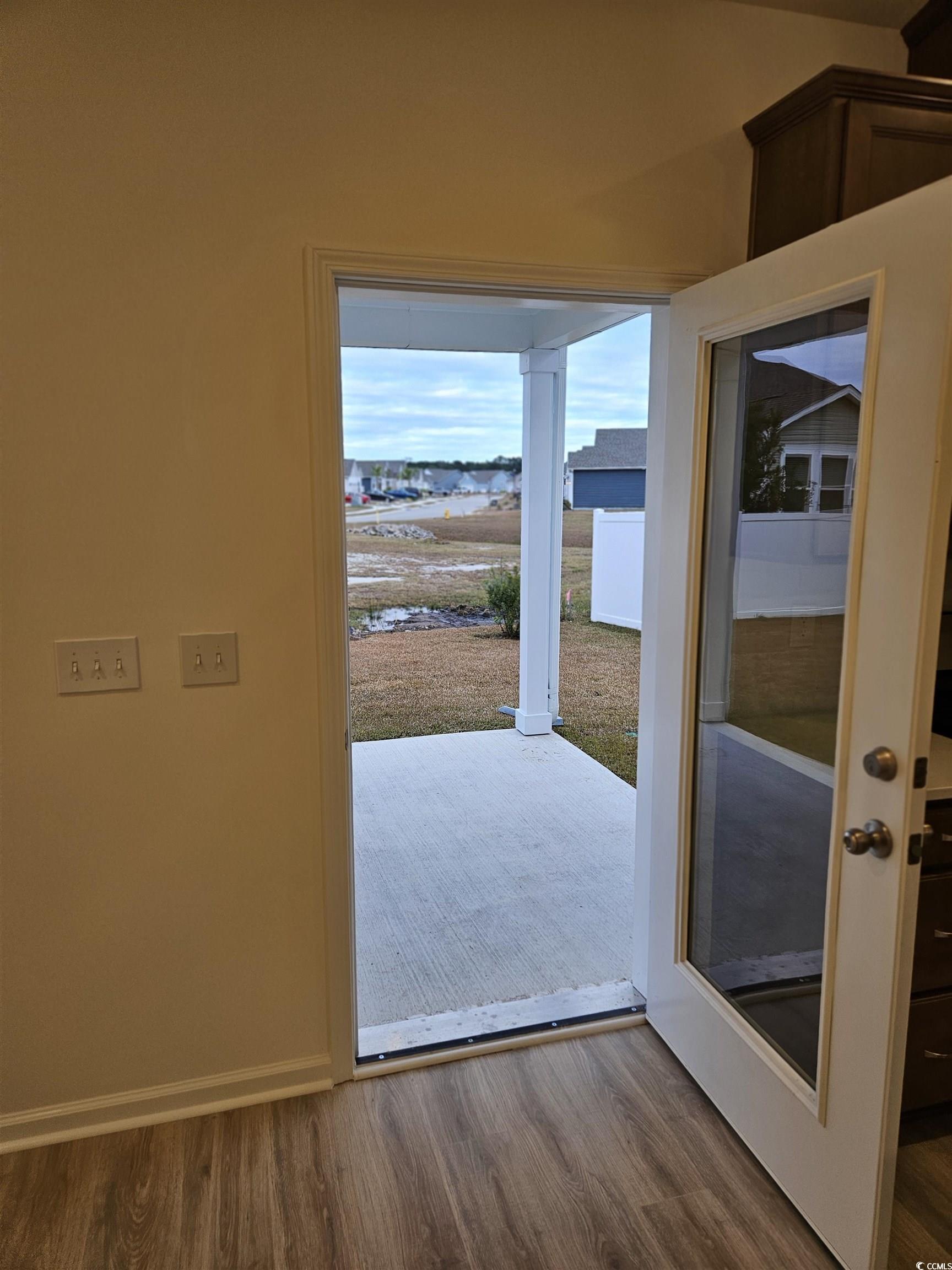 371 Kapalua Loop Little River, SC 29566 - Photo 29 of 37 Doorway featuring wood finished floors and baseboards
