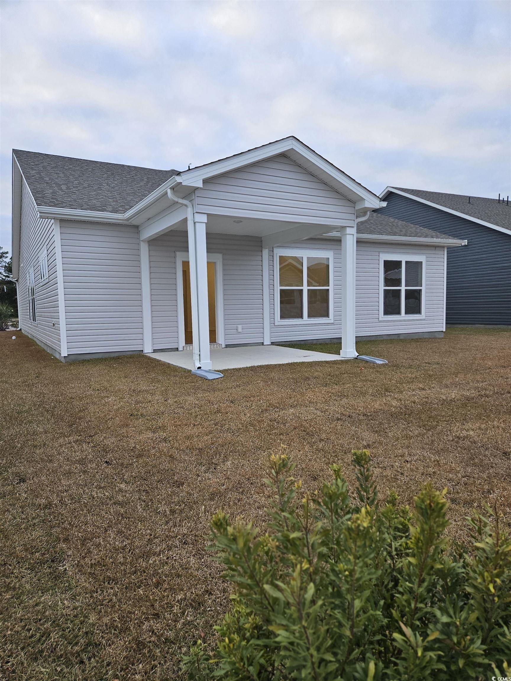 371 Kapalua Loop Little River, SC 29566 - Photo 31 of 37 Ranch-style house featuring a patio, a shingled roof, and a front yard