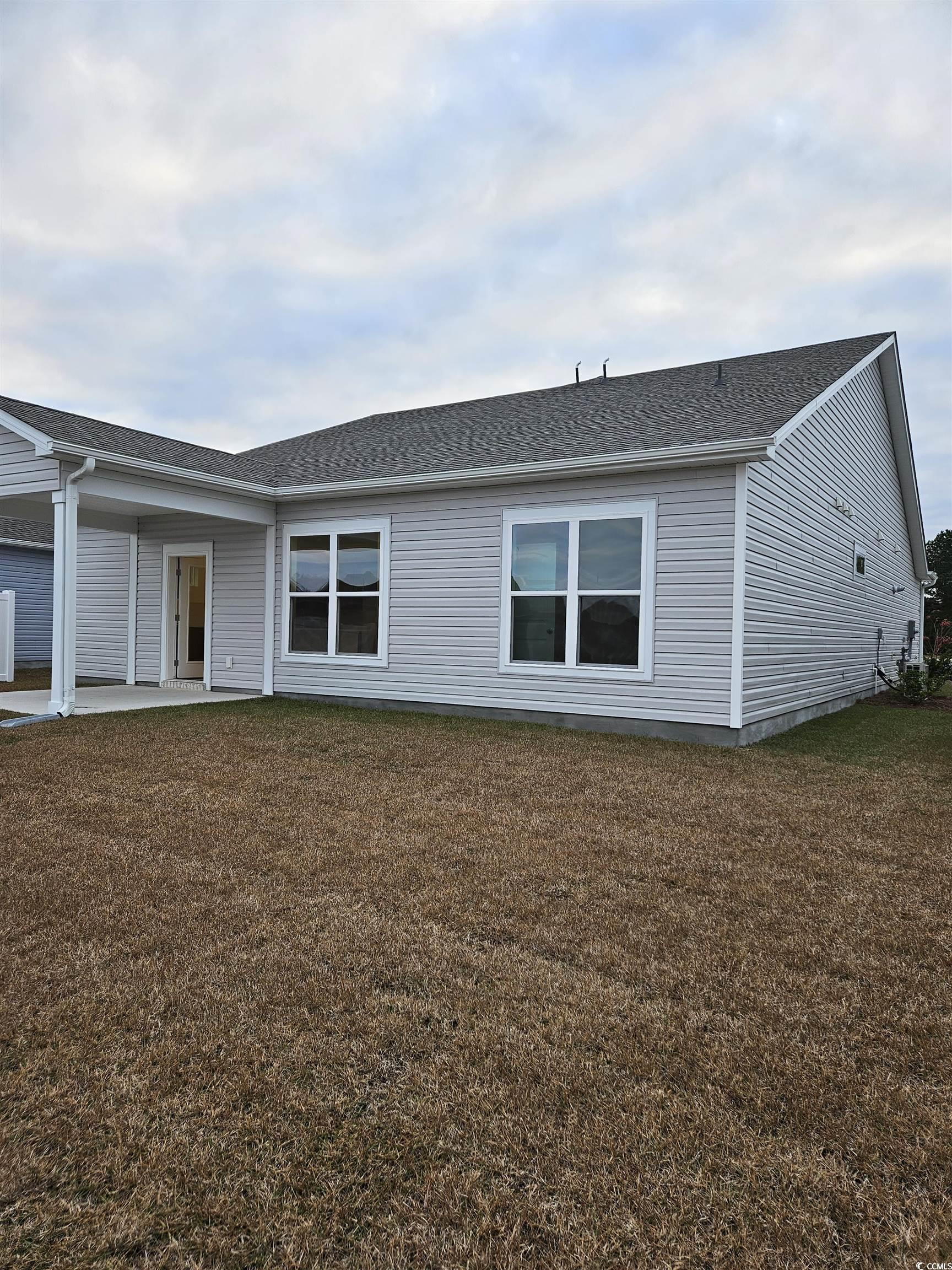371 Kapalua Loop Little River, SC 29566 - Photo 32 of 37 Back of property with a patio, roof with shingles, and a yard