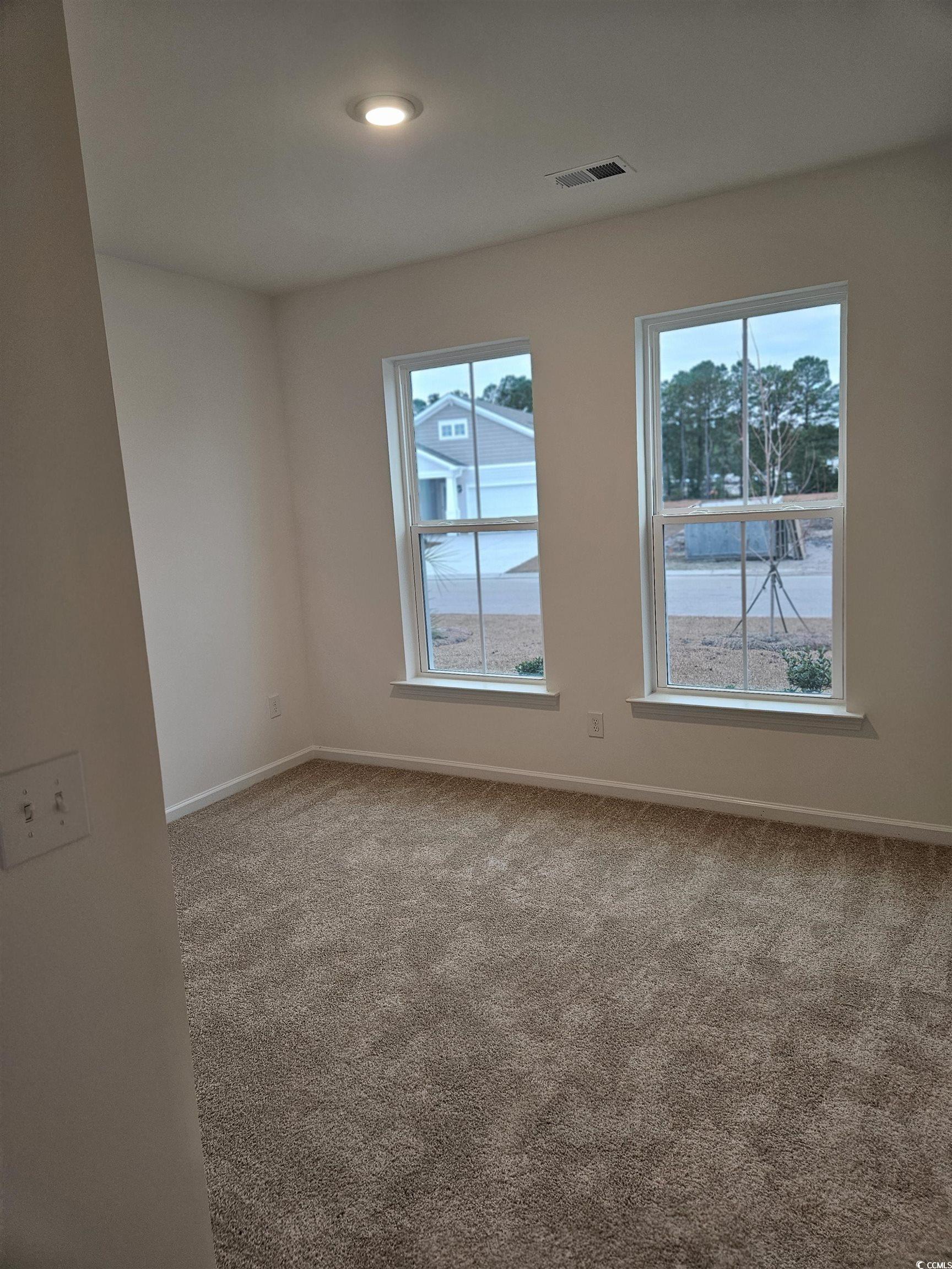 371 Kapalua Loop Little River, SC 29566 - Photo 4 of 37 Unfurnished room featuring healthy amount of natural light, light colored carpet, and recessed lighting