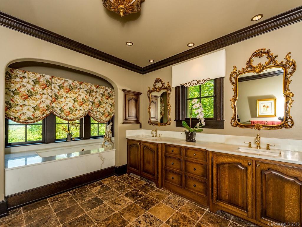 1929 Tree View Trail Arden, NC 28704 - Photo 14 of 35 a bathroom with a sink mirror and window