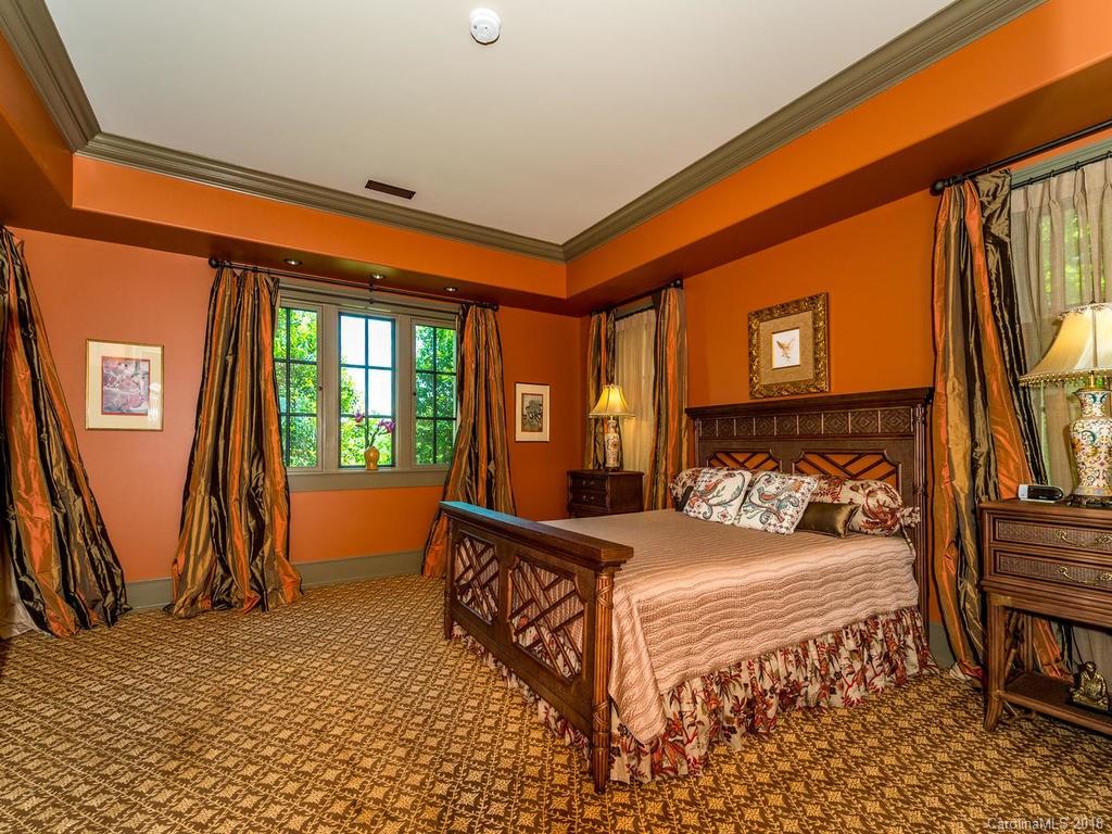 1929 Tree View Trail Arden, NC 28704 - Photo 19 of 35 a bedroom with a bed next to a window