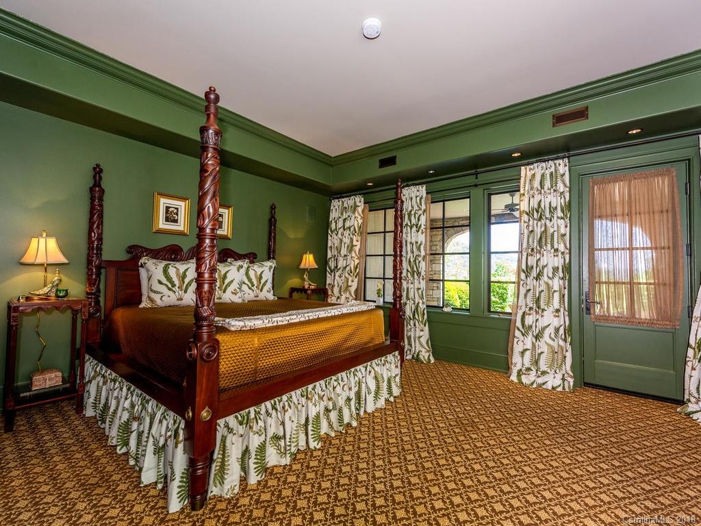 1929 Tree View Trail Arden, NC 28704 - Photo 22 of 35 a bedroom with a bed and large windows