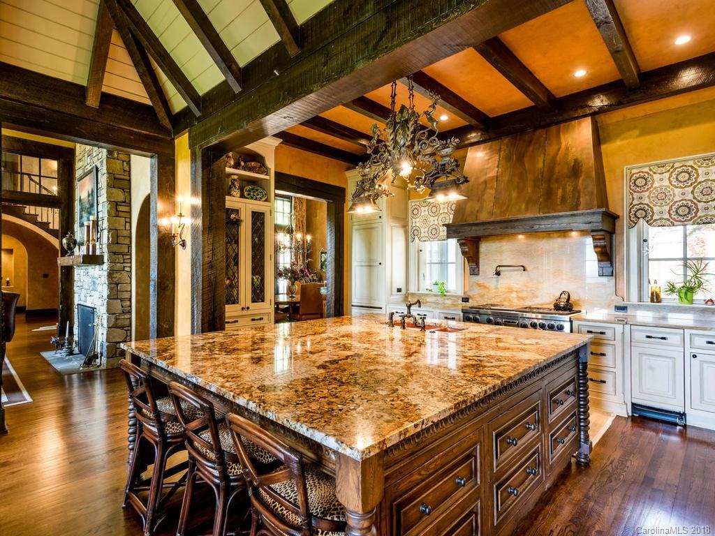 1929 Tree View Trail Arden, NC 28704 - Photo 8 of 35 a kitchen with stainless steel appliances granite countertop a stove and a wooden floors