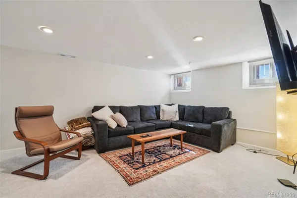a living room with furniture and a rug