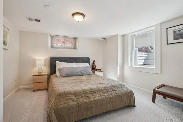 a bedroom with a bed and a television