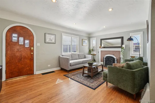 a living room with furniture and a fireplace