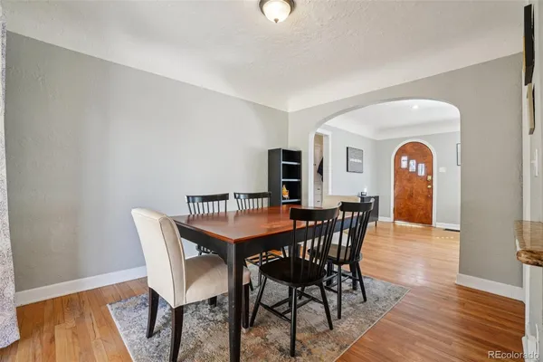 a dining room with furniture and wooden floor