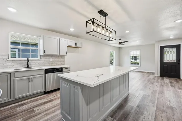 a kitchen with a sink and wooden cabinets