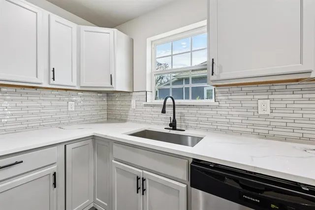 a kitchen with a sink and cabinets