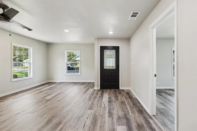 wooden floor in an empty room with a window