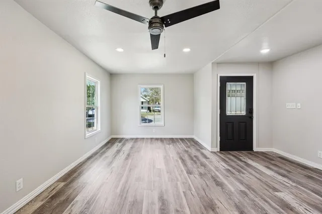 wooden floor in an empty room with a window