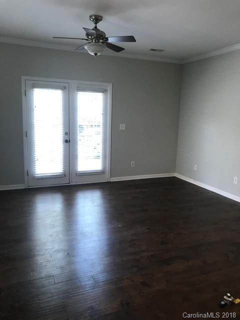14925 Scothurst Lane Charlotte, NC 28277 - Photo 3 of 9 an empty room with wooden floor and windows