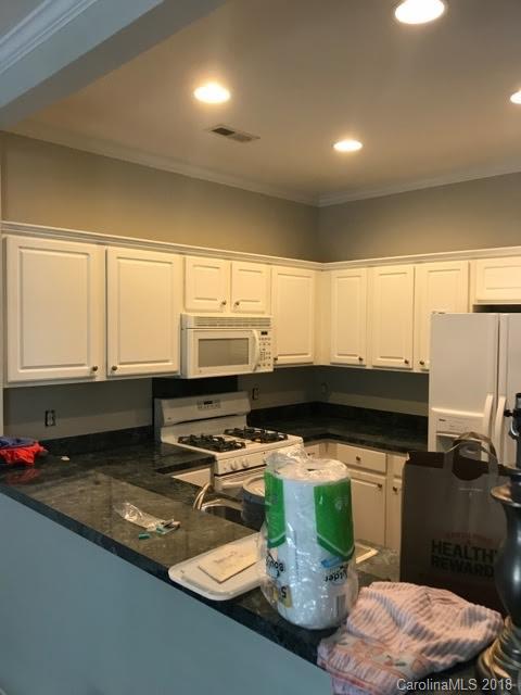 14925 Scothurst Lane Charlotte, NC 28277 - Photo 5 of 9 a kitchen with stainless steel appliances a stove a sink and a microwave