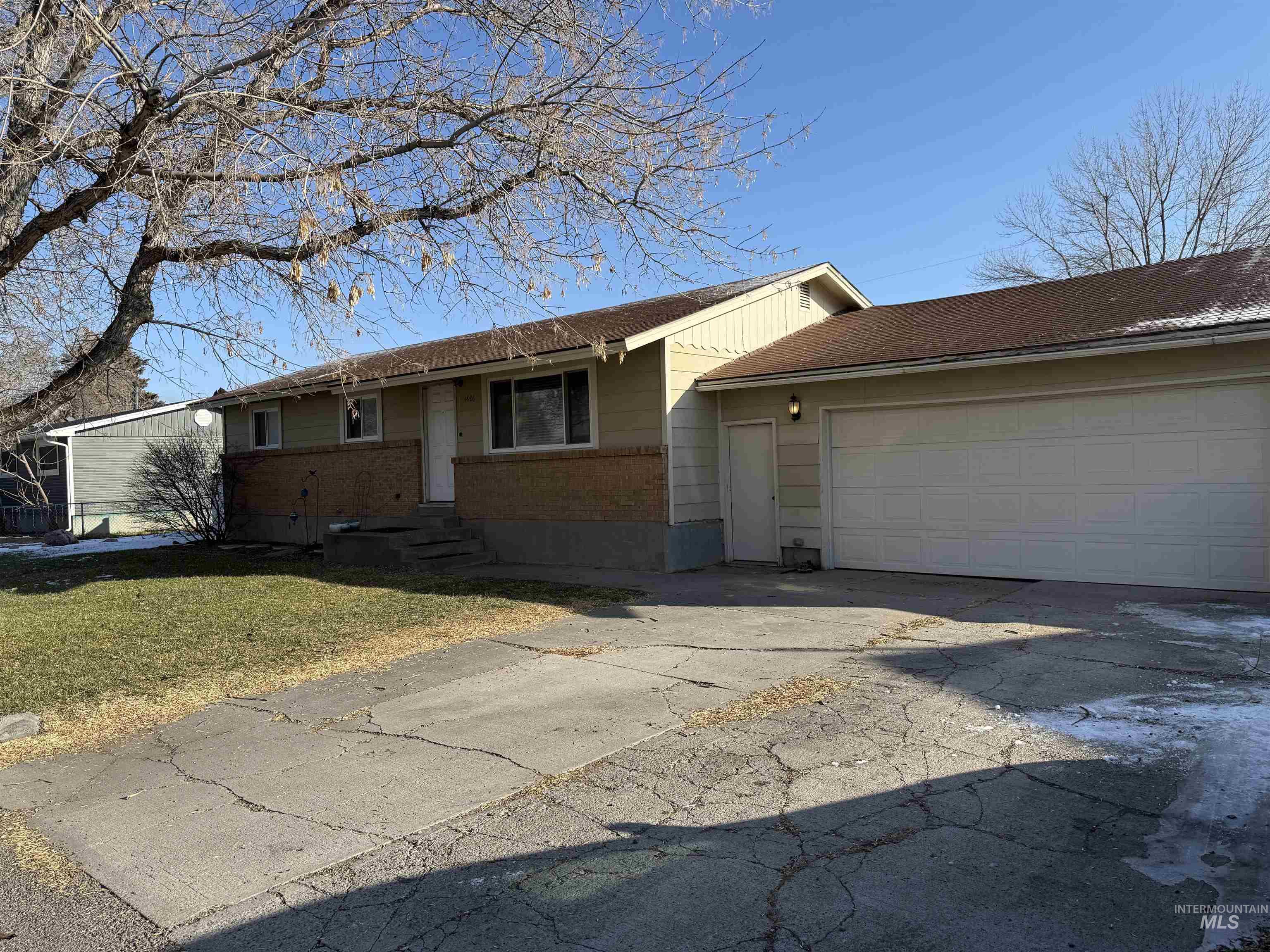 4926 Easy Street Chubbuck, ID 83202 - Photo 1 of 29 Single story home with brick siding, driveway, a front lawn, and a garage